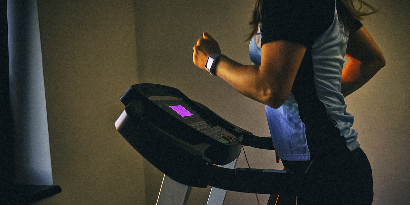 An image of a person running on a treadmill in their home
